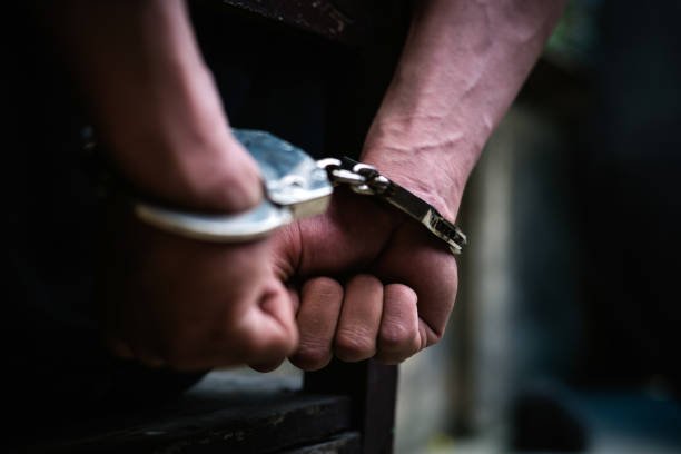 man-on-the-chair-in-handcuffs-rear-view-and-closeup